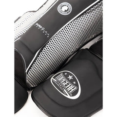 Close-up of Topgear Titan shin guard showing dotted side panel and foot protector with logo