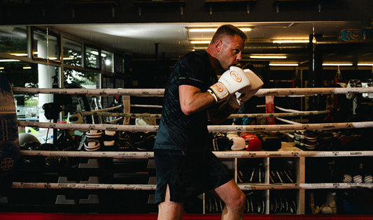 Boxer wearing training boxing gloves during conditioning workout inside boxing ring