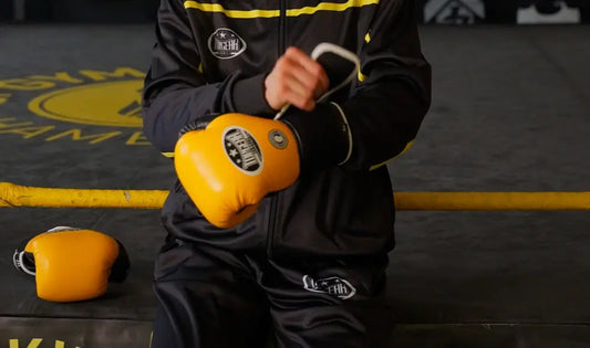 Boxer holding Topgear sports yellow boxing gloves for training
