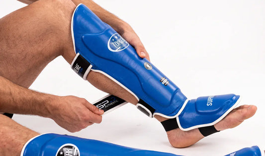Athlete wearing supreme shin guard in blue-color