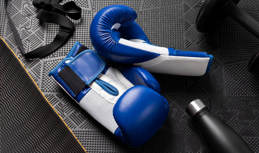 Blue Velcro boxing gloves showing wrist strap design and training use