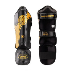 Close-up of TOPGEAR Fight Club shin guard showing front side panel and TOPGEAR logo on foot protector and back view with straps