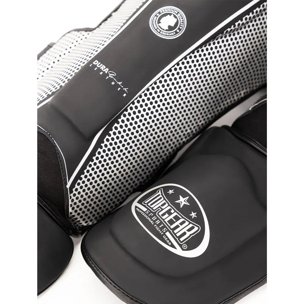 Close-up of Topgear Titan shin guard showing dotted side panel and foot protector with logo